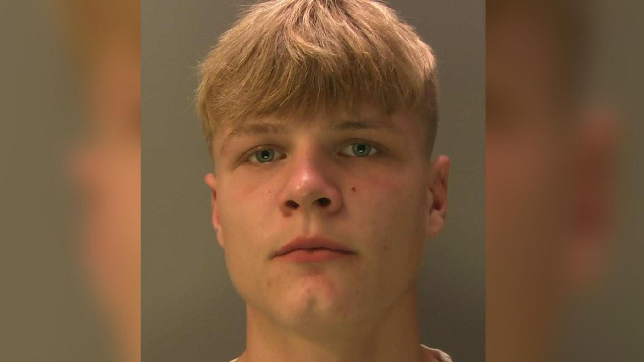 A police custody image of Rhys Hedges who is looking at the camera and has blond hair. Only his head is in shot.