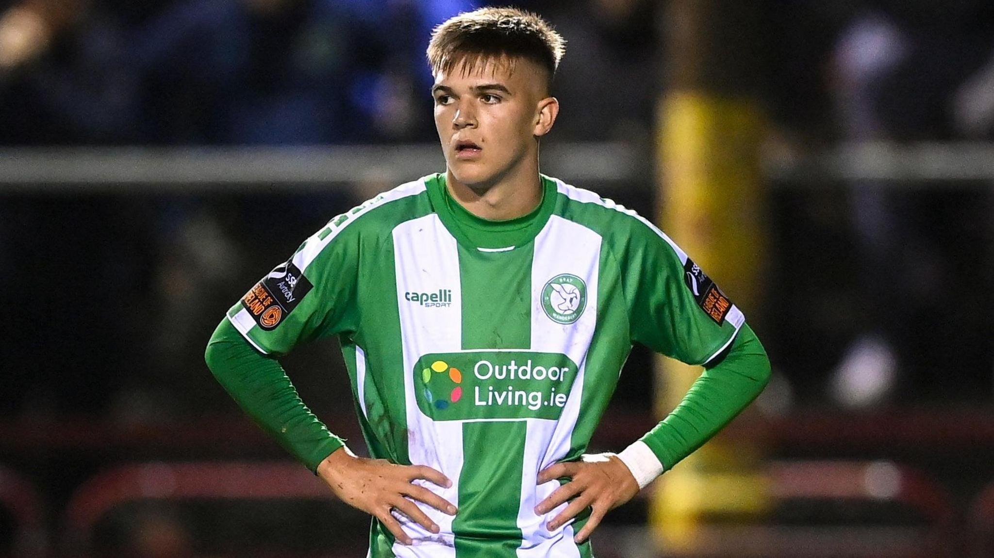 Billy O'Neill, wearing the Bray Wanderers green and white striped home shirt, looks dejected as he stands with his mouth slightly open and hands on his hips during the promotion and relegation play-off final against Waterford in November 2025
