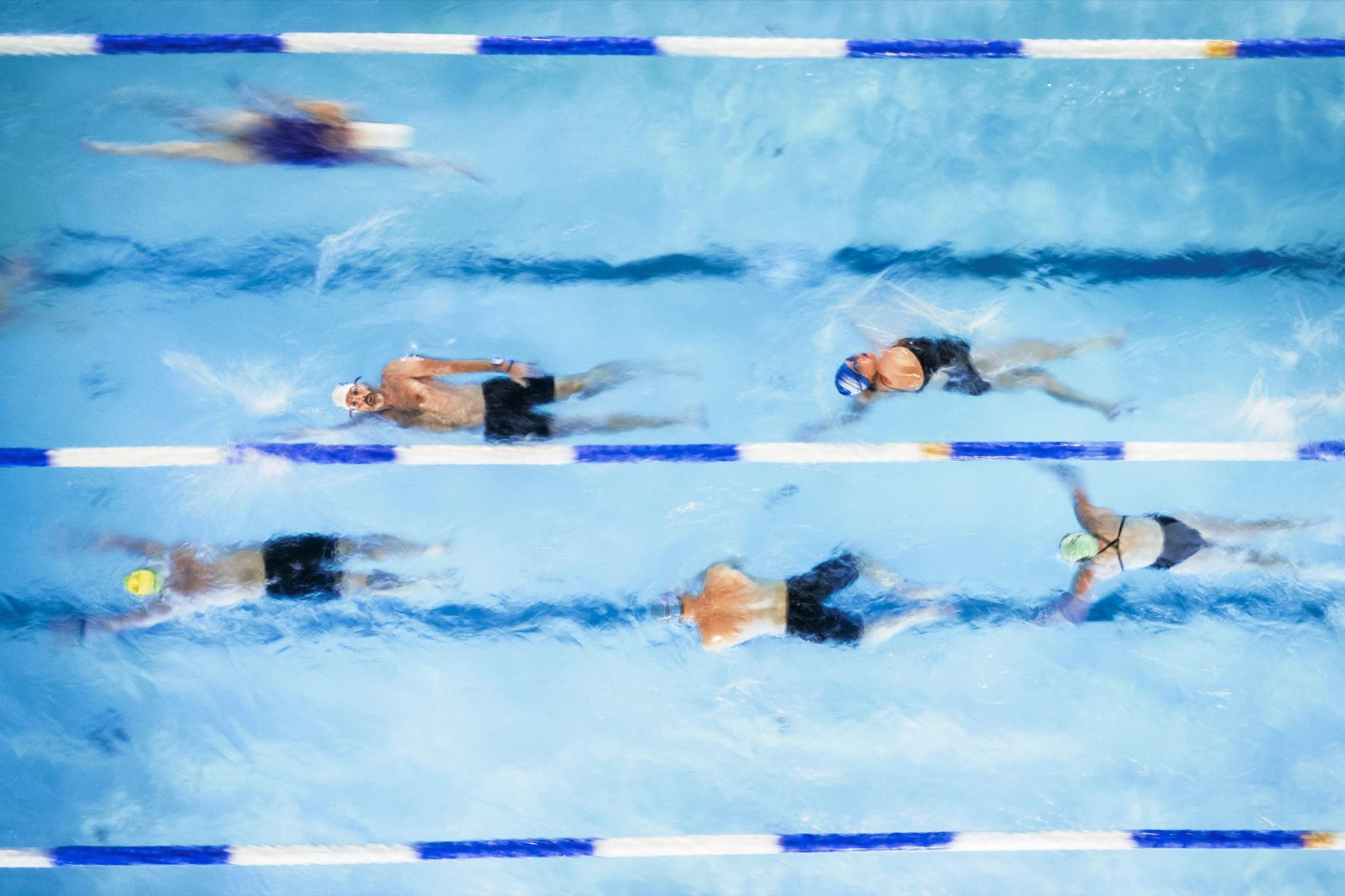 An aerial view of people swimming laps at night at Hampton Pool on 14 November 2024 in London, England.