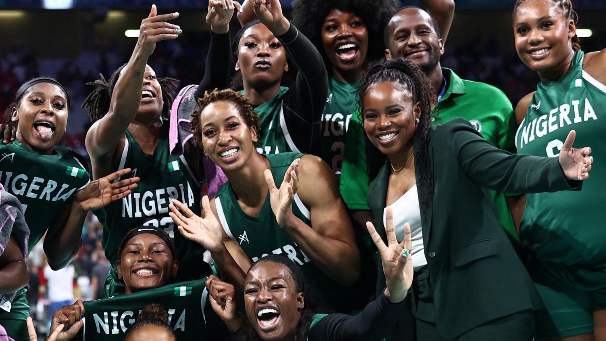 Nigerian basketball players and coaching staff celebrate reaching the quarter-finals at Paris 2024