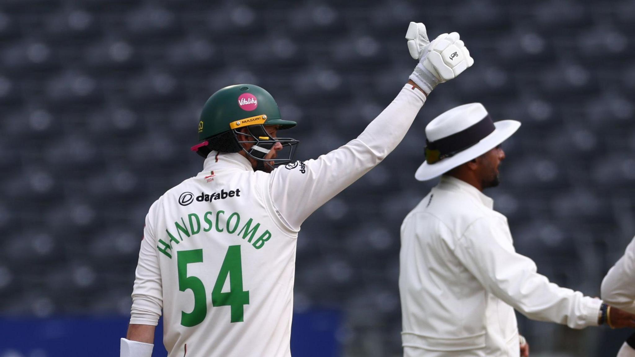 Peter Handscomb gives the thumbs up to the balcony after reaching 50