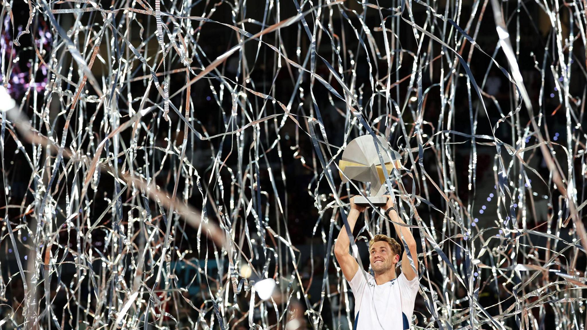 Norway's Casper Ruudcelebrates with the trophy after his victory in the Men's Singles Final on Day Thirteen of the Mutua Madrid Open at La Caja Magica in Madrid, Spain