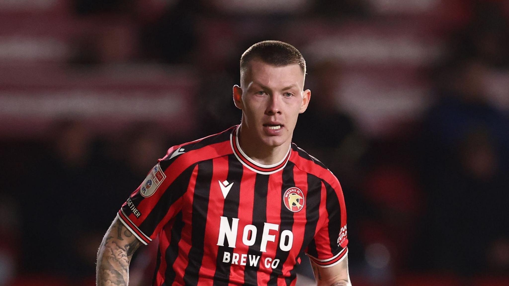 Kacpar Lopata in the red and black stripes of loan club Walsall