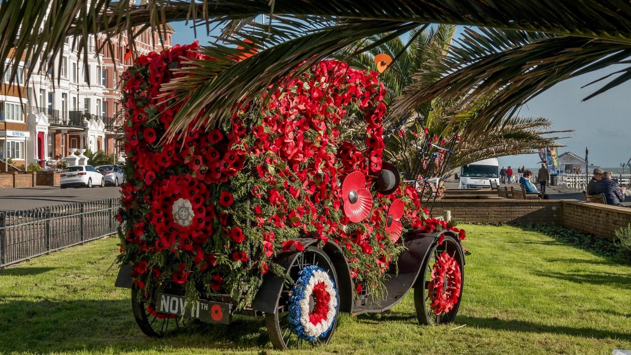 Replica vintage car covered in poppies