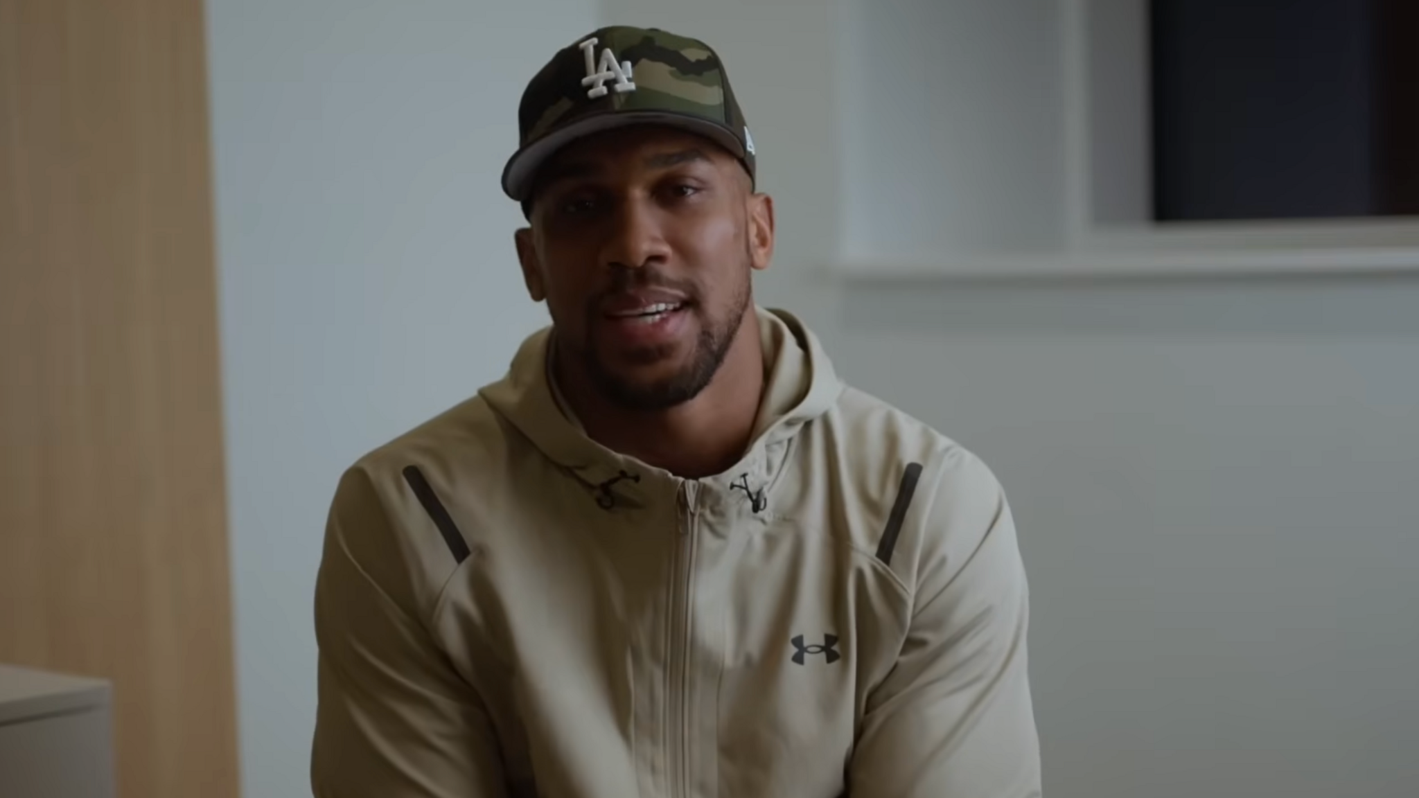 Anthony Joshua sits in front of a camera for a Youtube video
