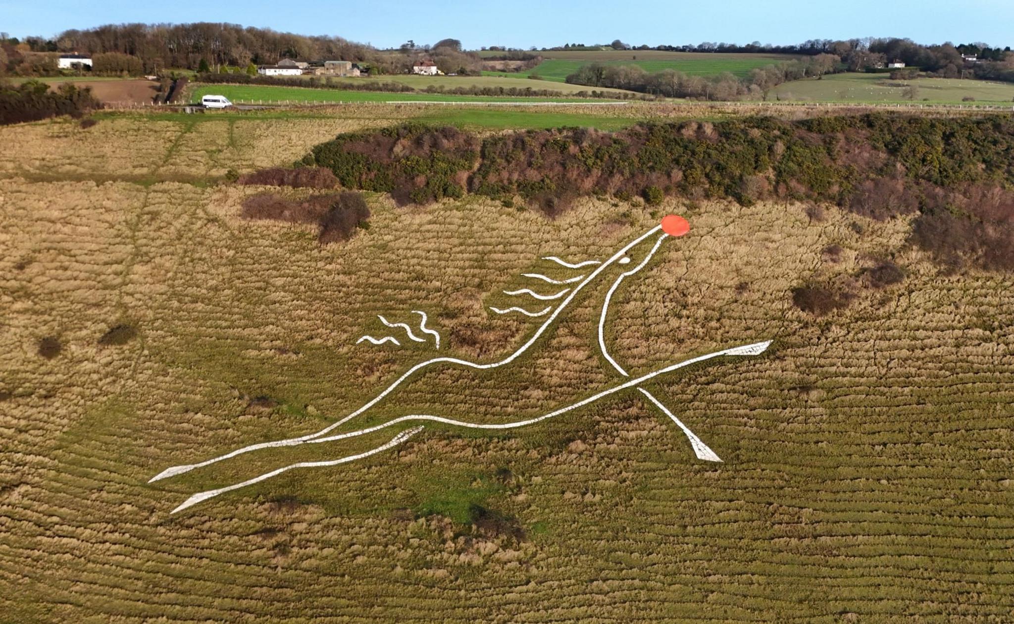 A view of the White Horse, carved into Cheriton Hill, near Folkestone, Kent,  but with a round red nose, depicting the legendary Rudolph, the red-nosed reindeer.
