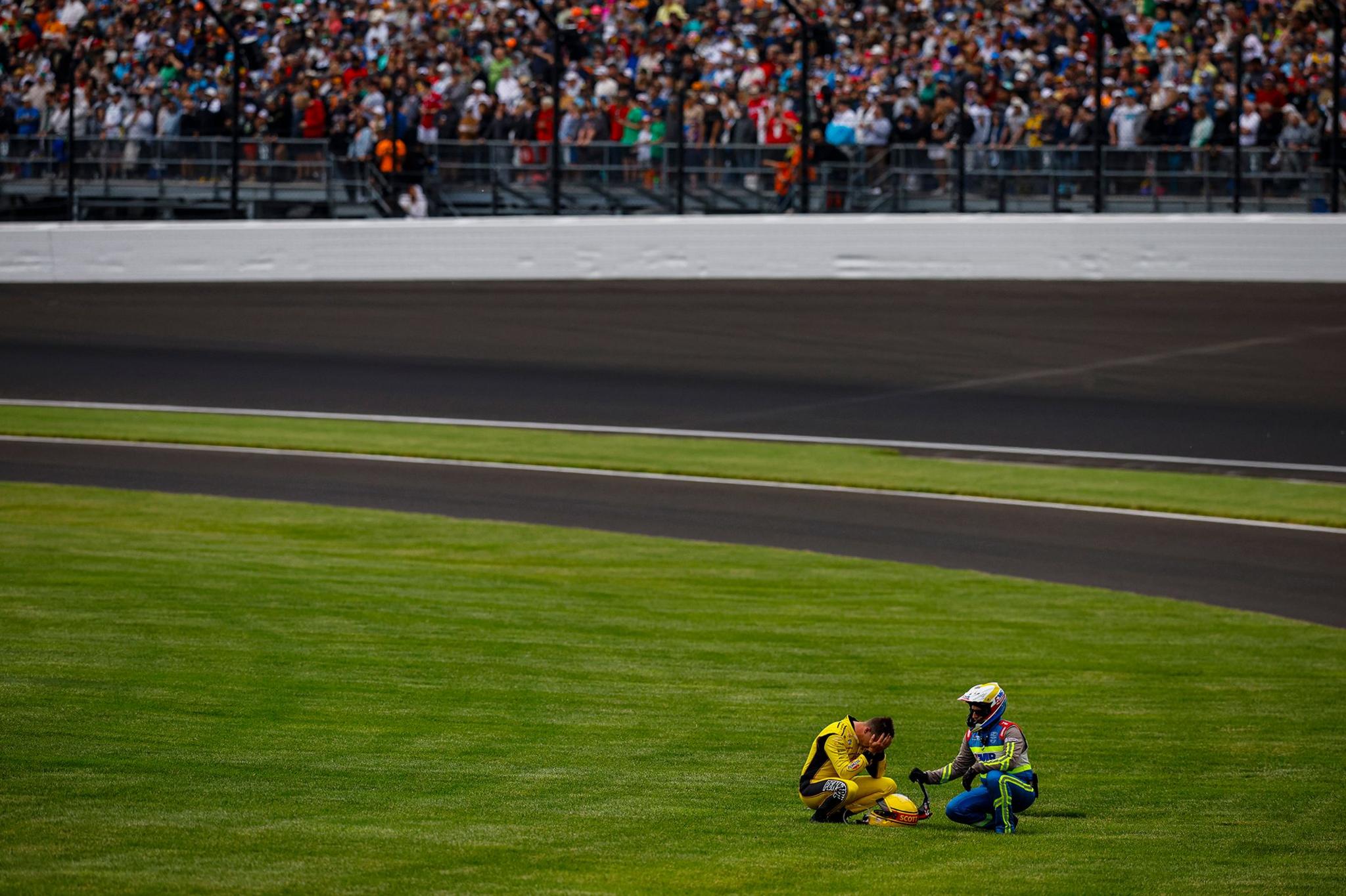 Scott McLaughlin Team Penske Chevrolet rests in the grass after his crash during the NTT IndyCar Series 109th Running of the Indianapolis 500 at Indianapolis Motor Speedway in Indianapolis, Indiana. Photo by Jake Galstad