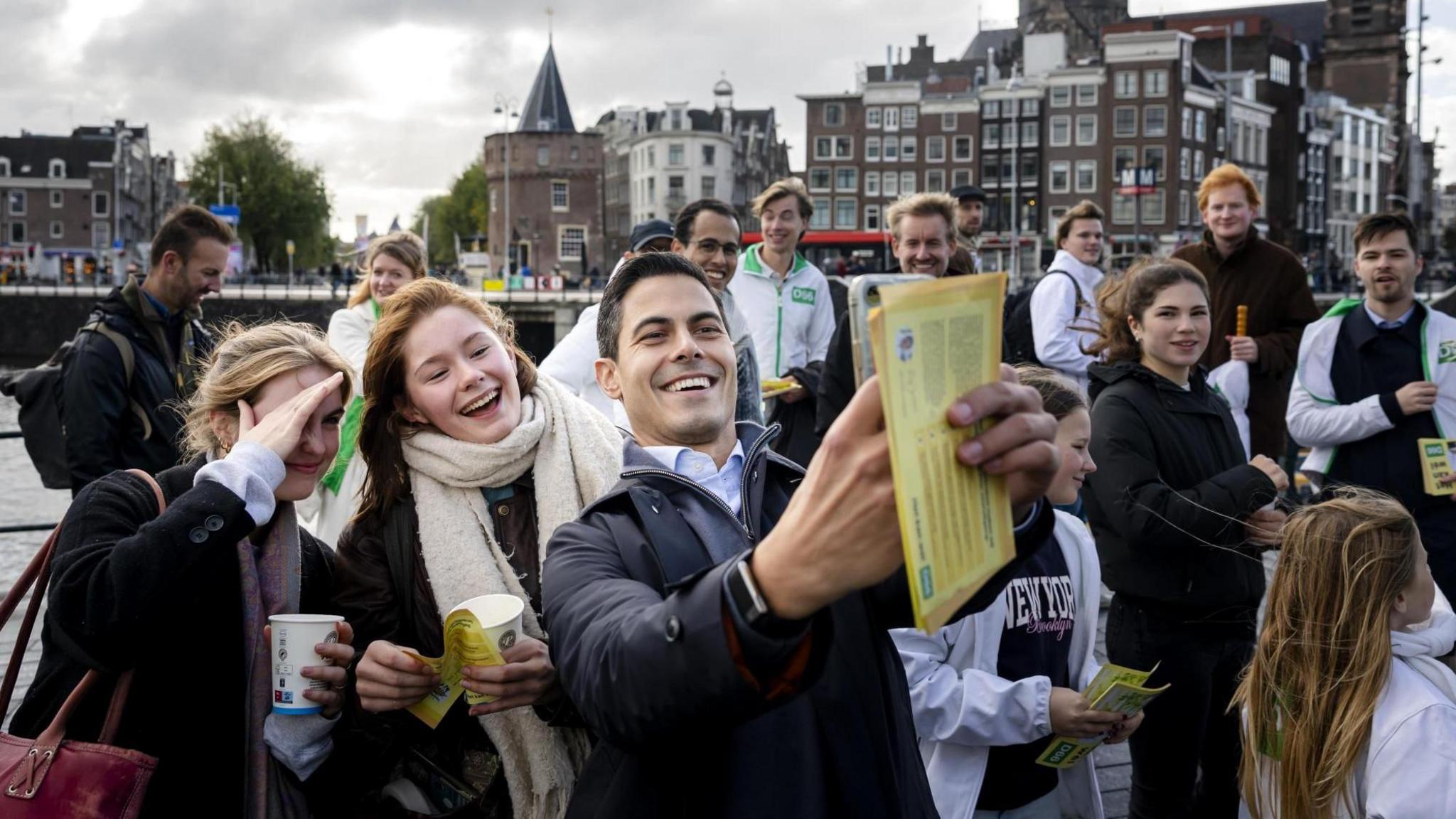 Rob Jetten takes a selfie with supporters on an Amsterdam street.