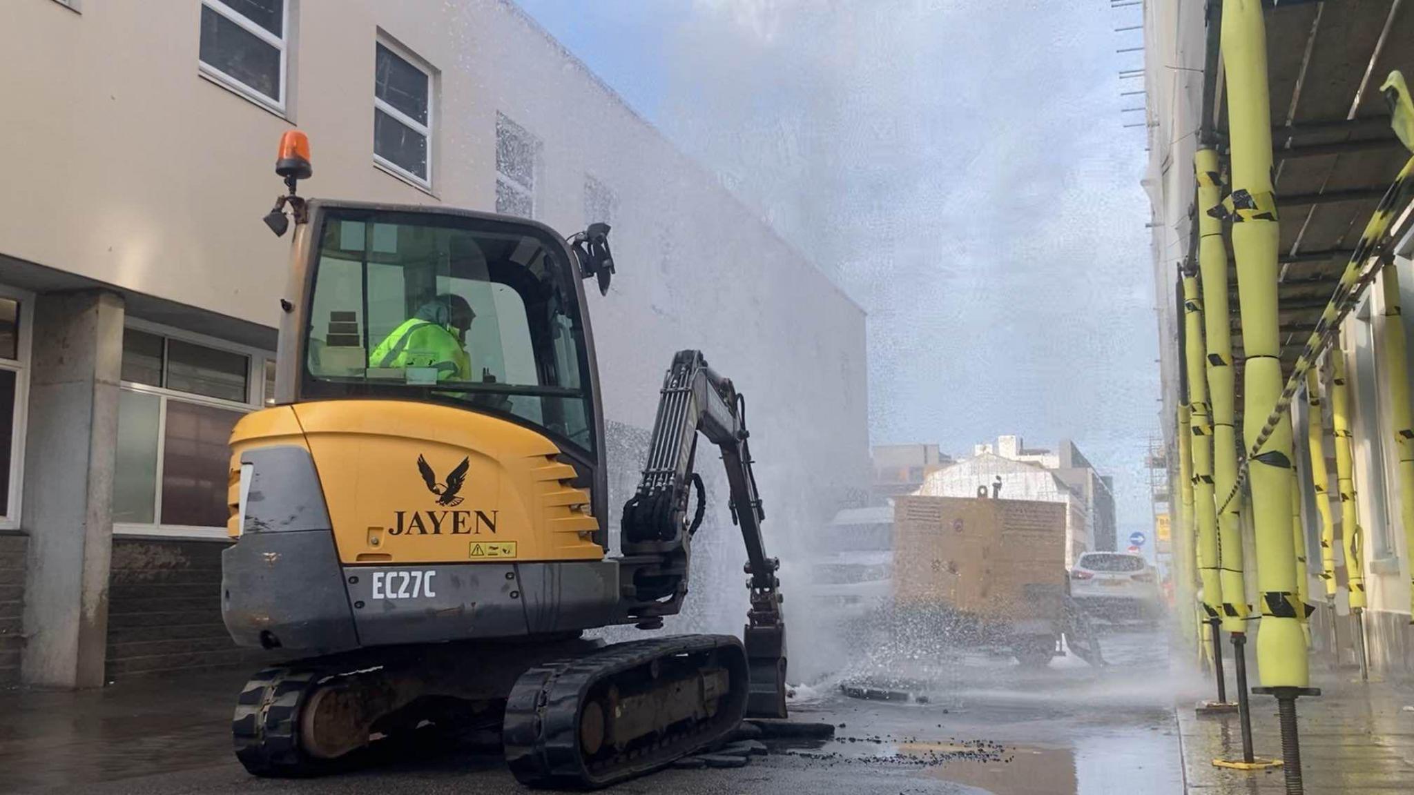 A Jersey Water engineer at the scene of a burst water main