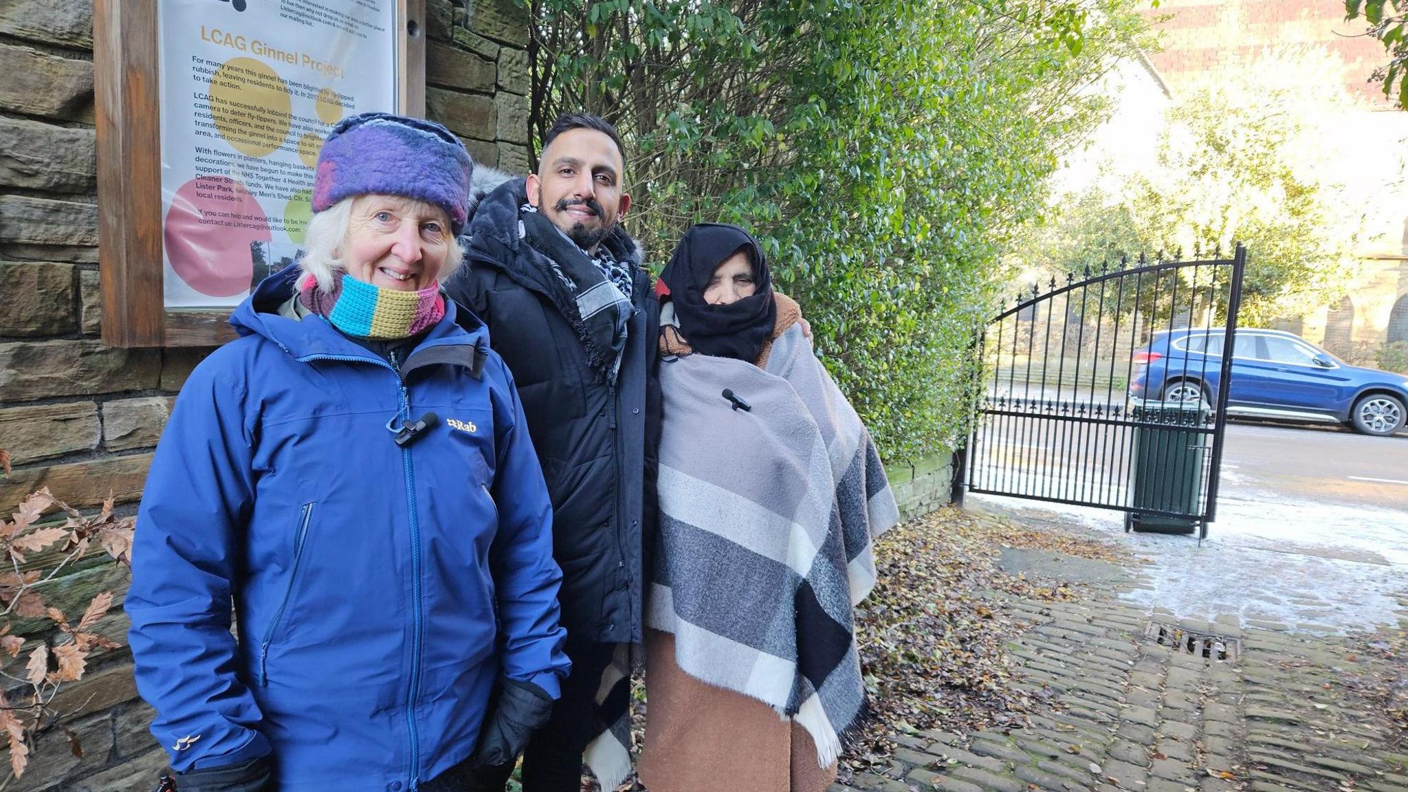 Three people in a ginnel