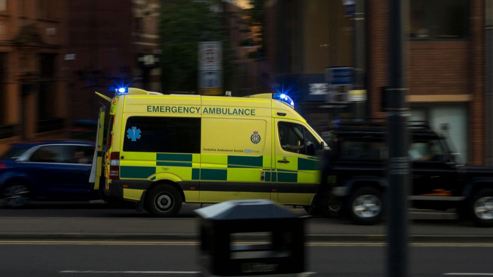 A Yorkshire ambulance with blue lights on in Leeds.