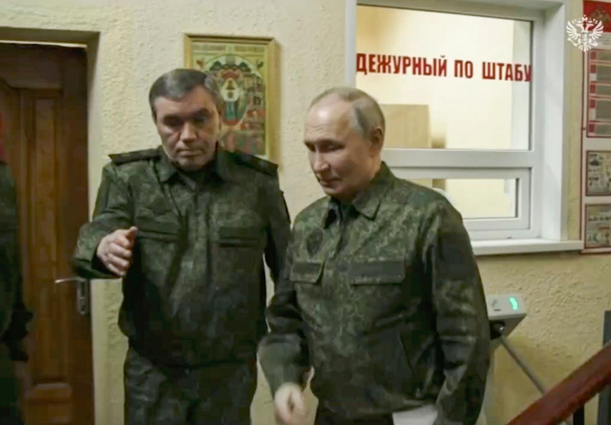 A still image taken from a handout video provided by the Russian Presidential Press Service shows Russian President Vladimir Putin (R) with Russian Chief of General Staff Gen. Valery Gerasimov during a visit to military headquarters in the Kursk region