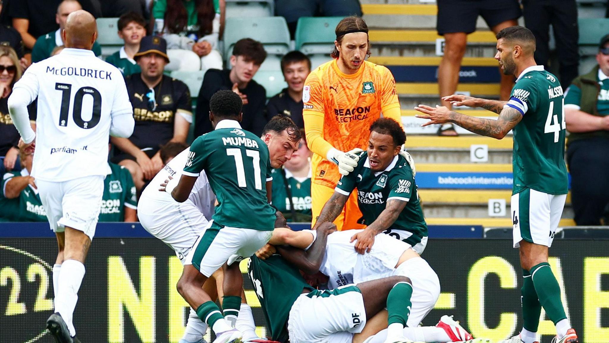 Plymouth Argyle and Barnsley players clash