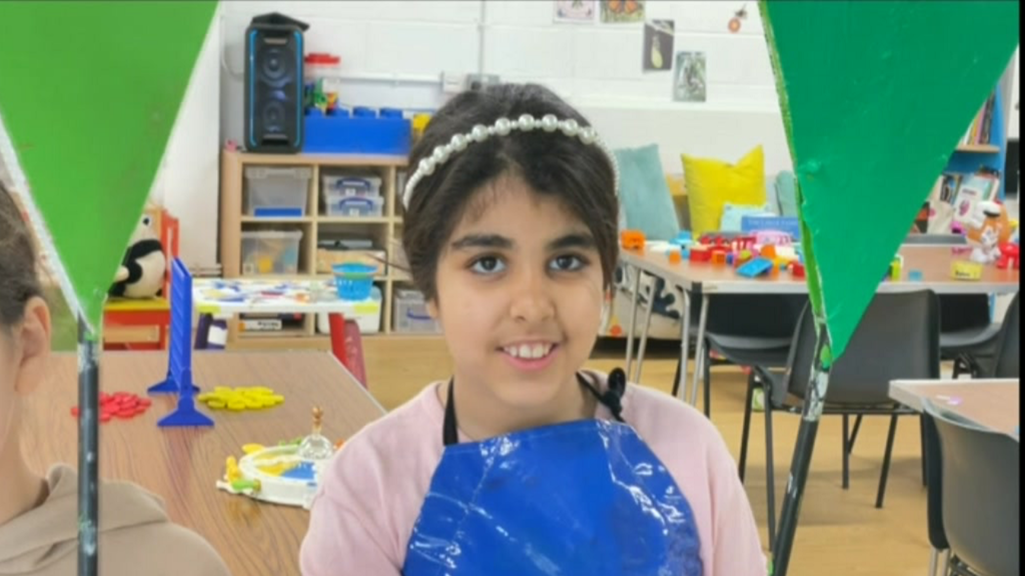 A young child painting memorials for Grenfell Tower victims 