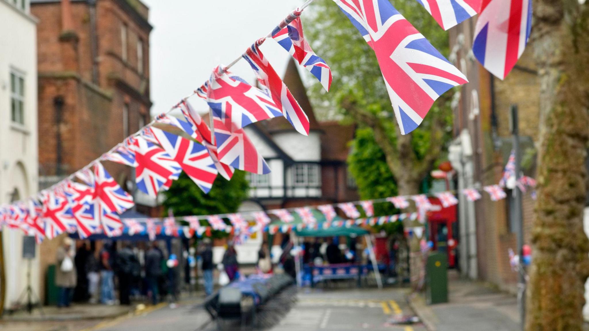 Royalty free stock photo of Union Jack flags bunting in local street party.