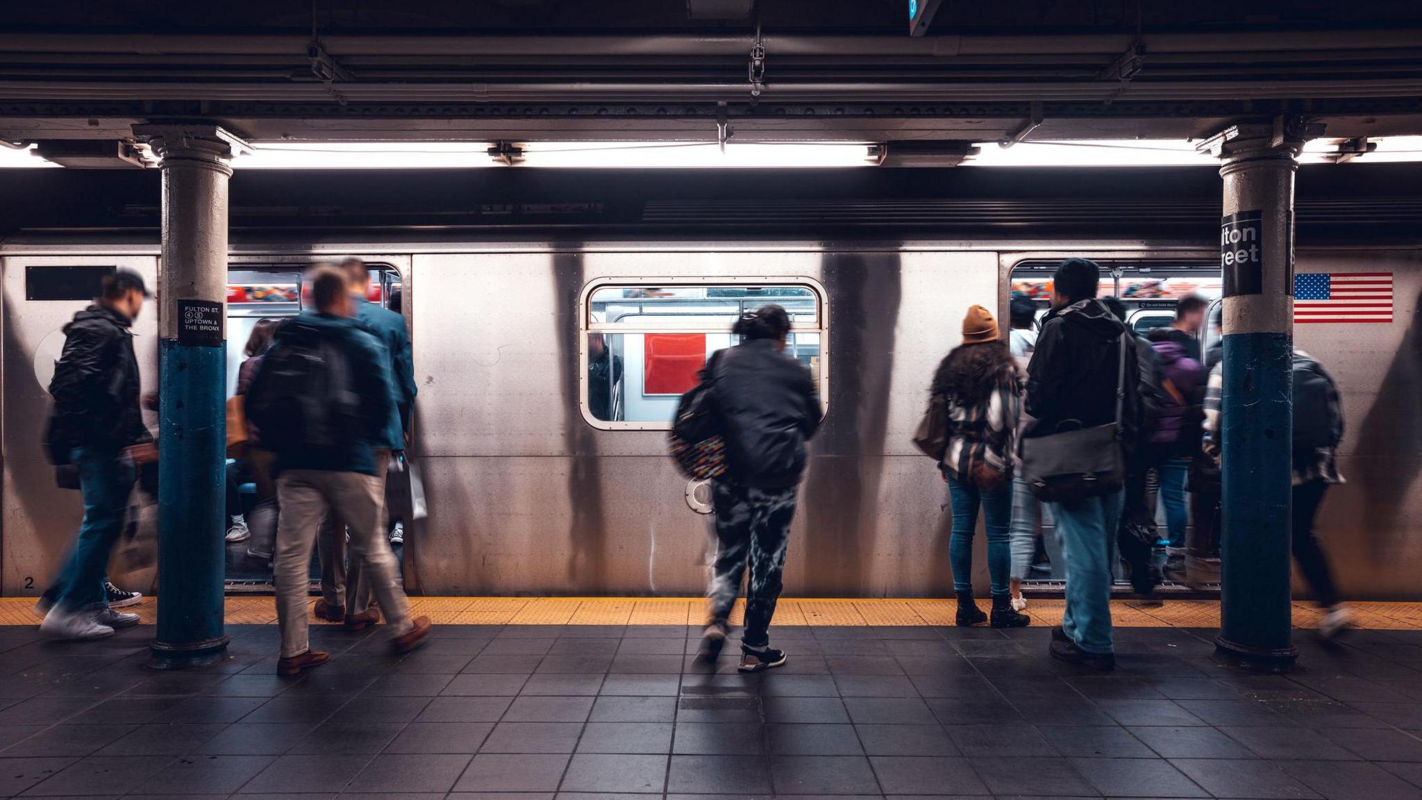 A number of commuters pictured boarding the New York Subway 