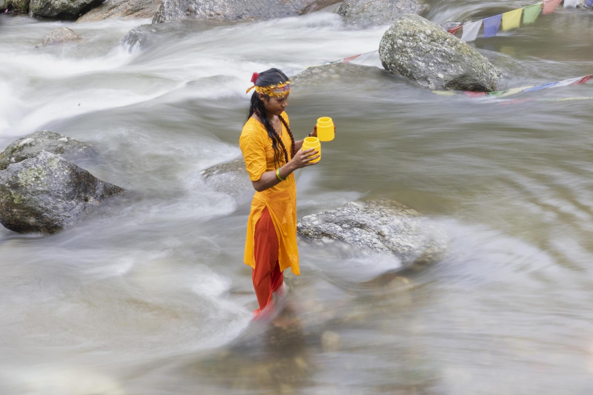 A Nepalese Hindu pilgrim takes a holy dip and collects water from the Bagmati River to worship Shiva