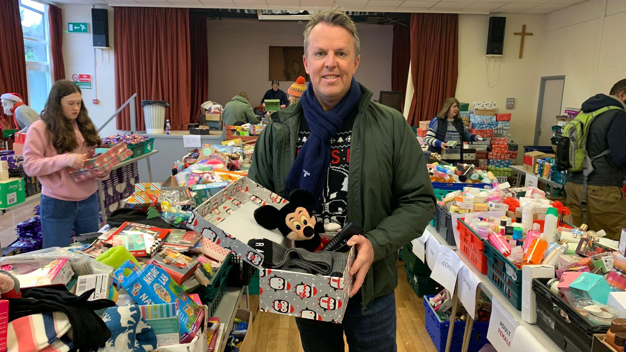 Graeme Swann holding a shoebox of gifts