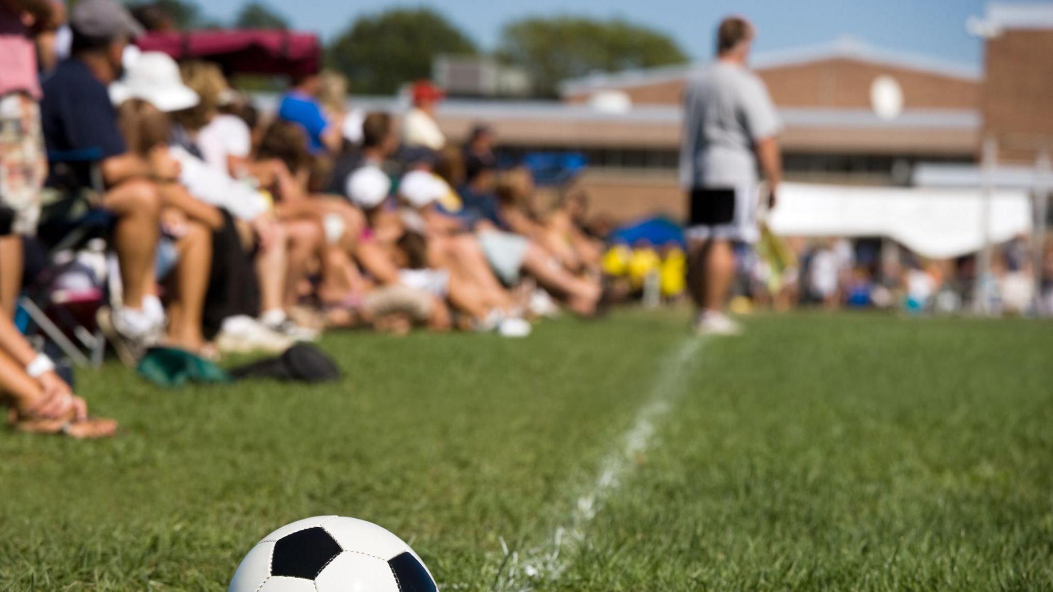 Parents on sidelines of football game
