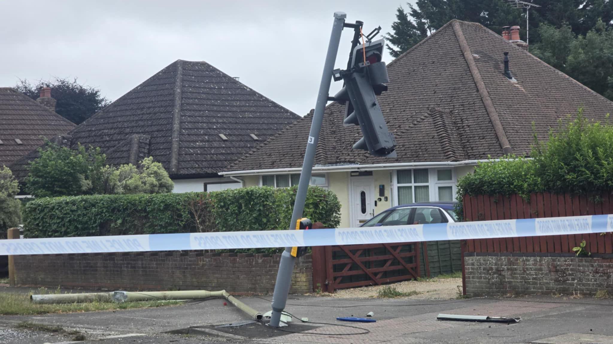 A traffic light can be seen leaning on a tilt in the area of the crash