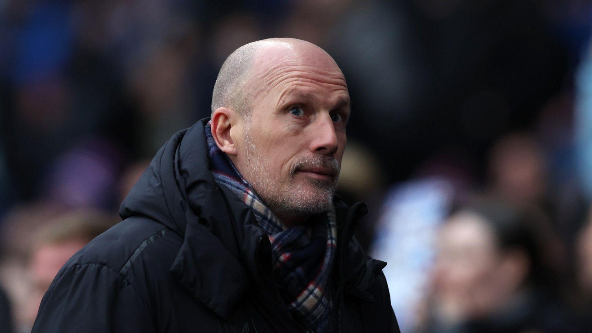 A photo of Philippe Clement wearing a black jacket and scarf