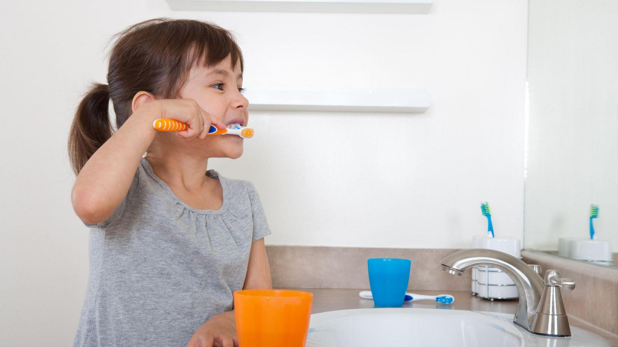 Girl brushing her teeth