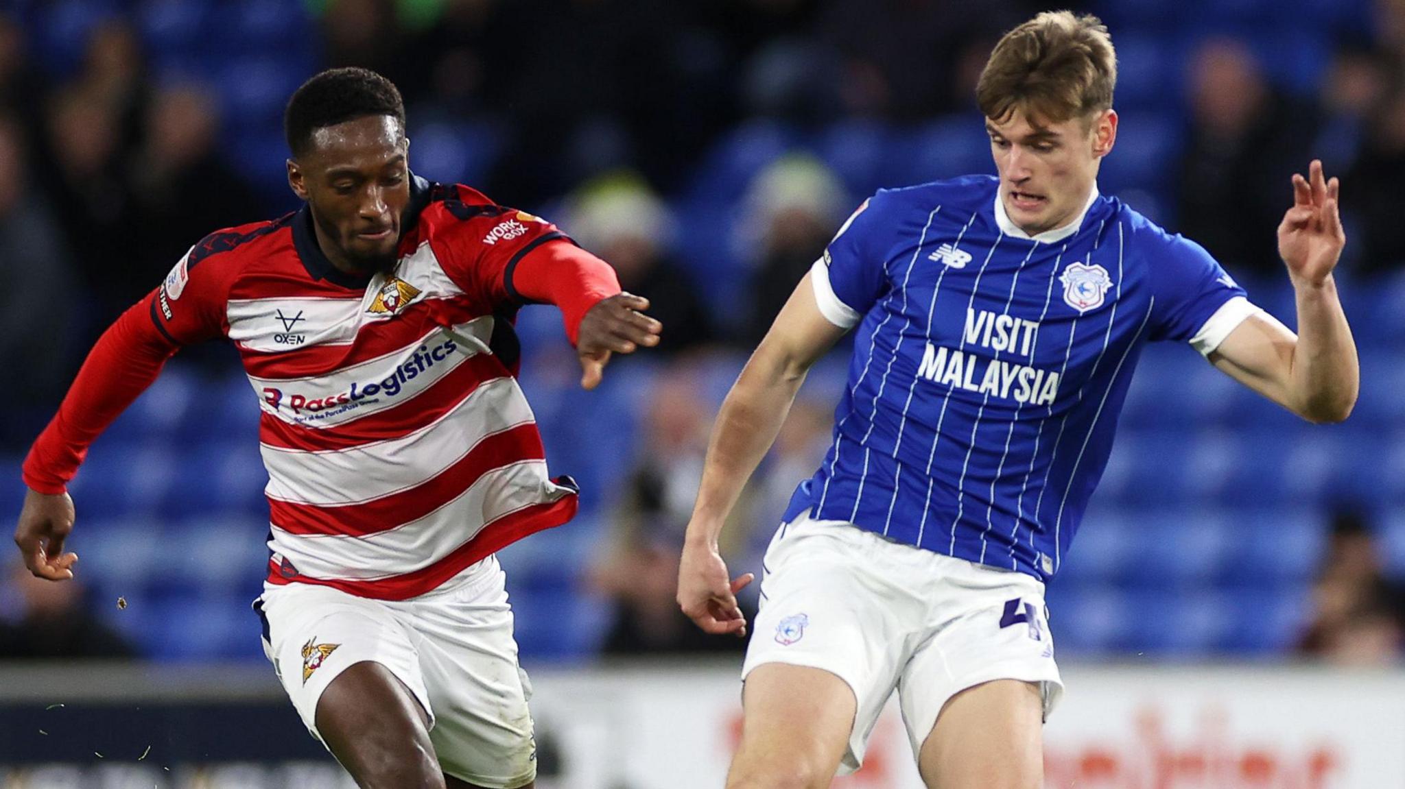 Dylan Lawlor (right) of Cardiff is challenged by Brandon Hanlan of Doncaster