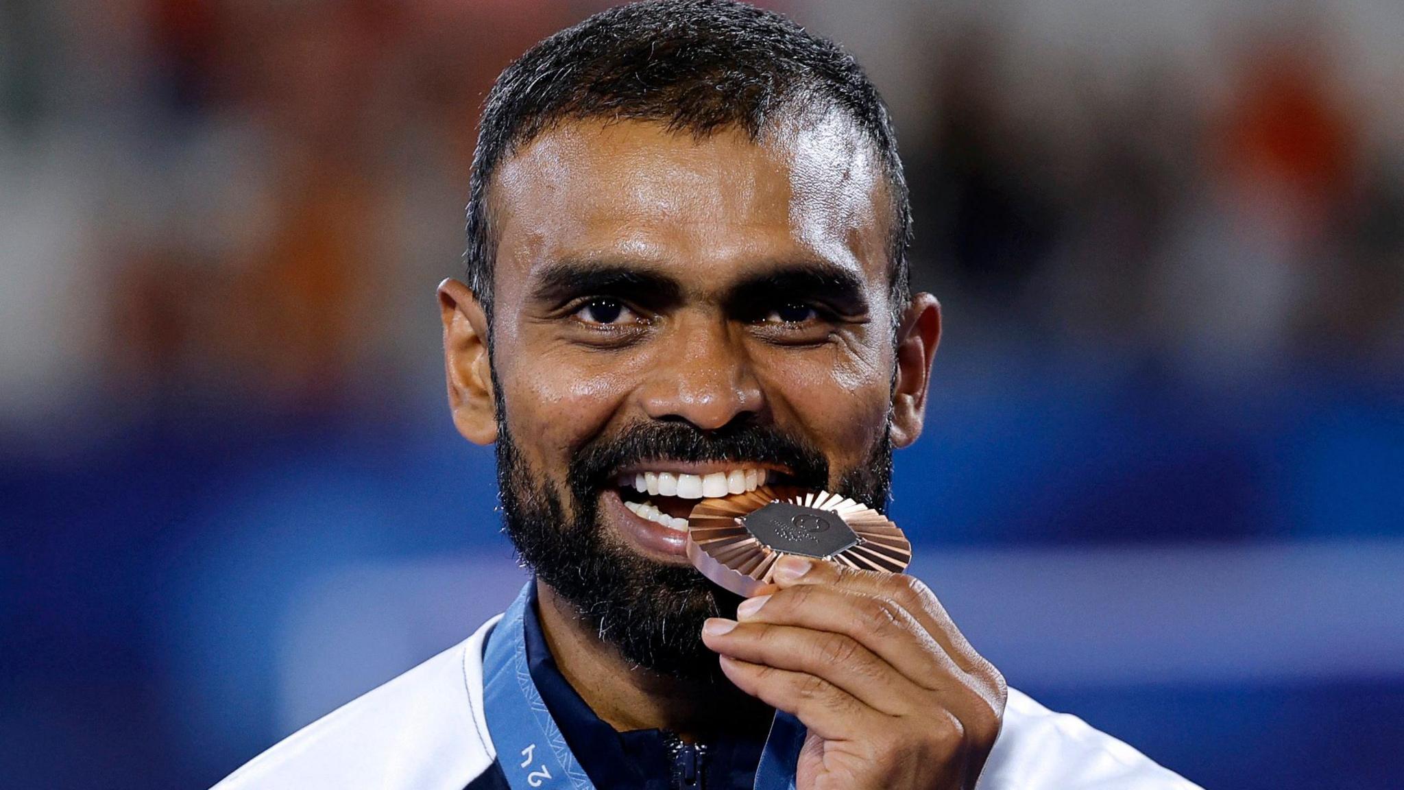 India's goalkeeper #16 Sreejesh Parattu Raveendran poses on the podium with his bronze medal af