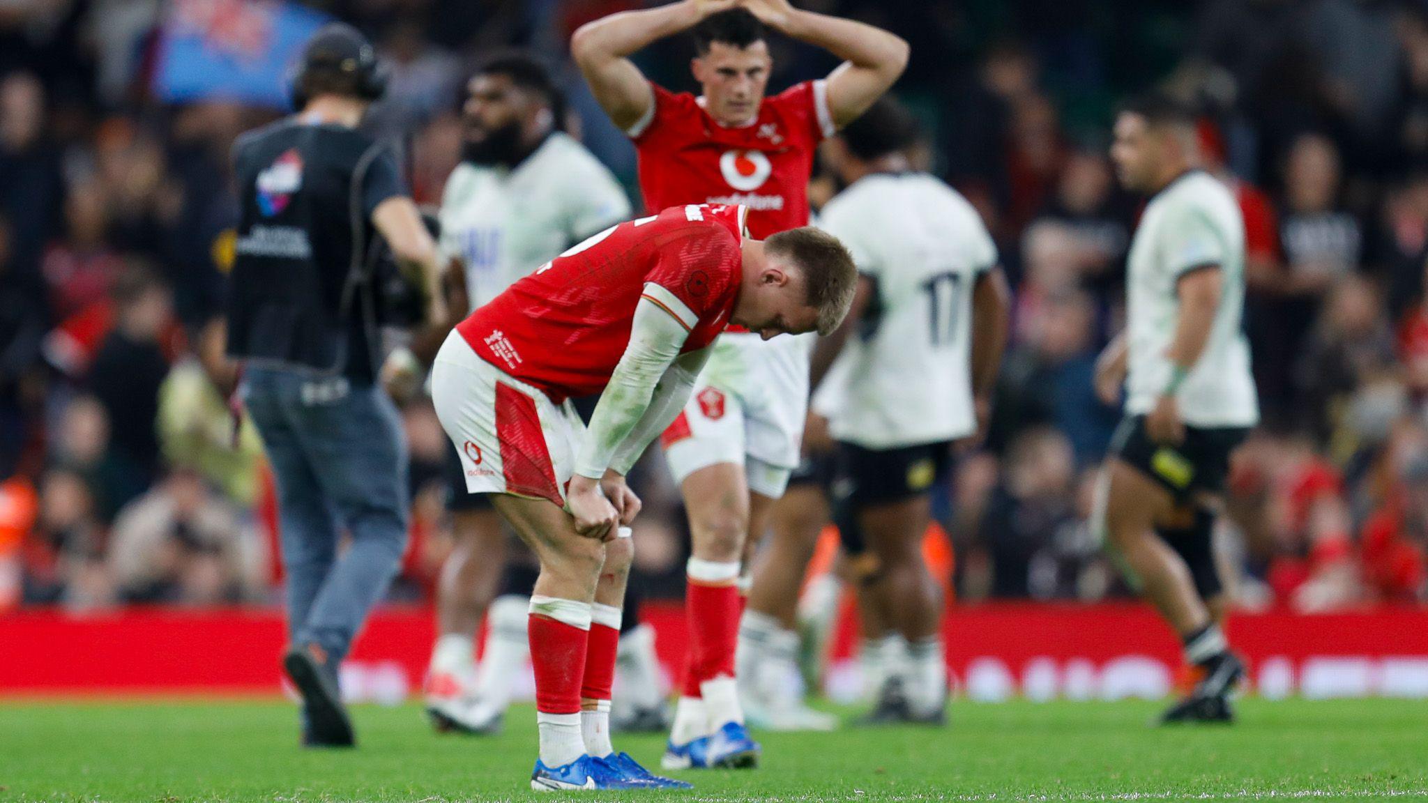 Wales players look down in disappointment at the final whistle against Fiji