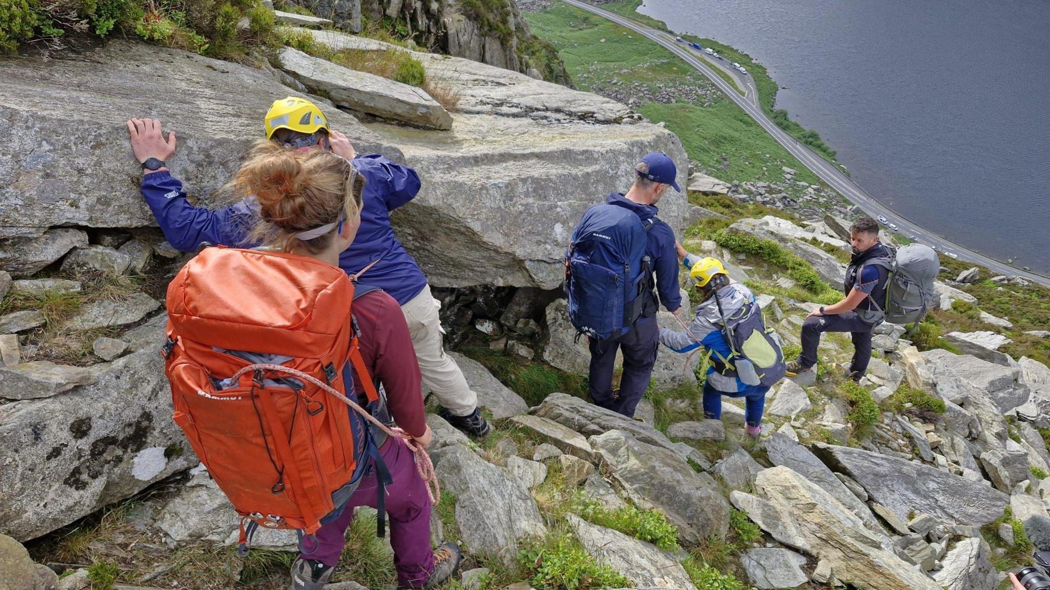 People being rescued from a mountainside