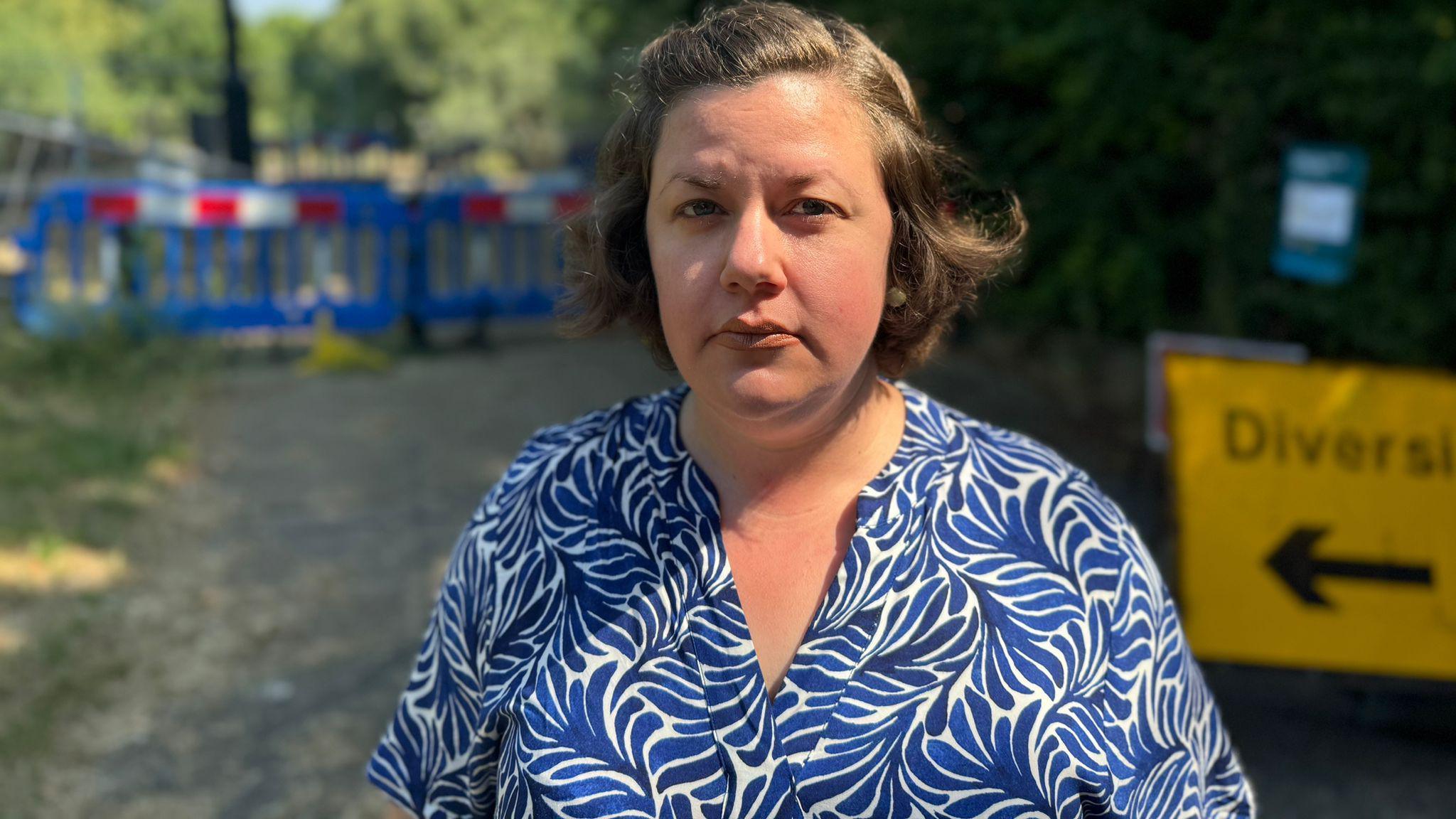 Colchester resident Steph Nissen standing in front of the collapsed weir in Castle Park