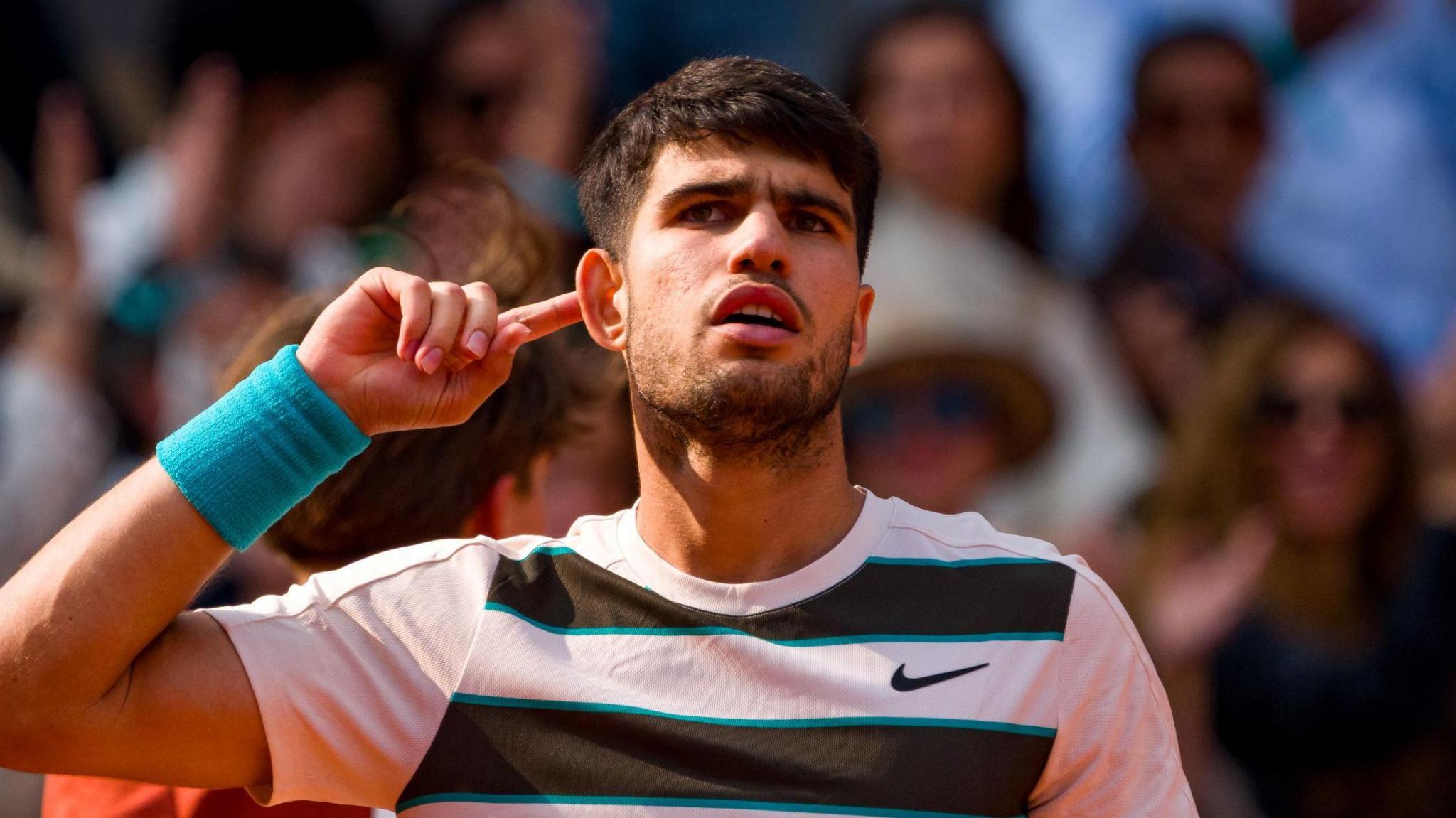 Carlos Alcaraz cups his ear to the French Open crowd 