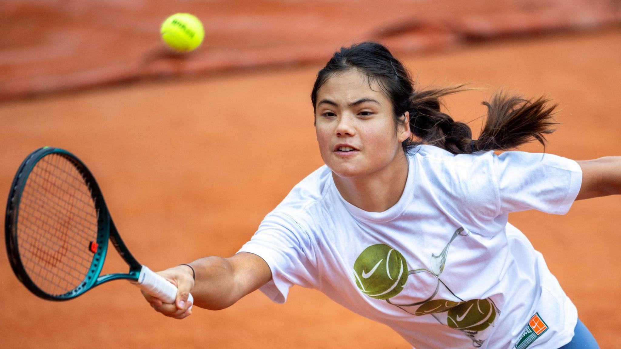 Emma Raducanu stretches for a ball in French Open practice