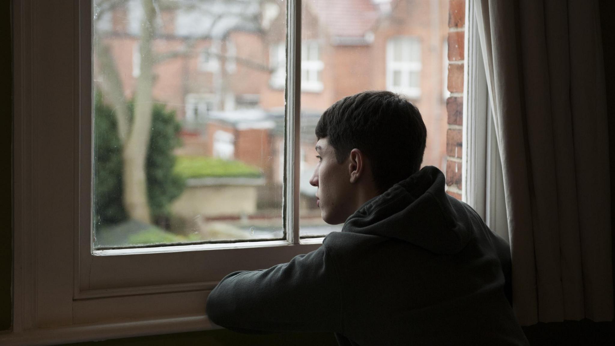 Young man looking out the window