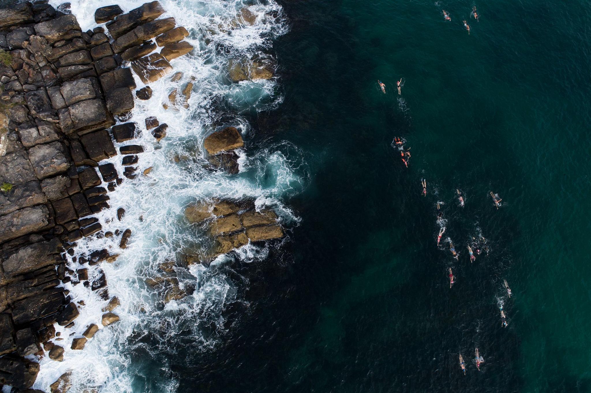 Swimmers from the Bold And Beautiful Swim Squad make their way from the South corner of Manly Beach in Sydney to Shelly Beach. Photo by Cameron Spencer