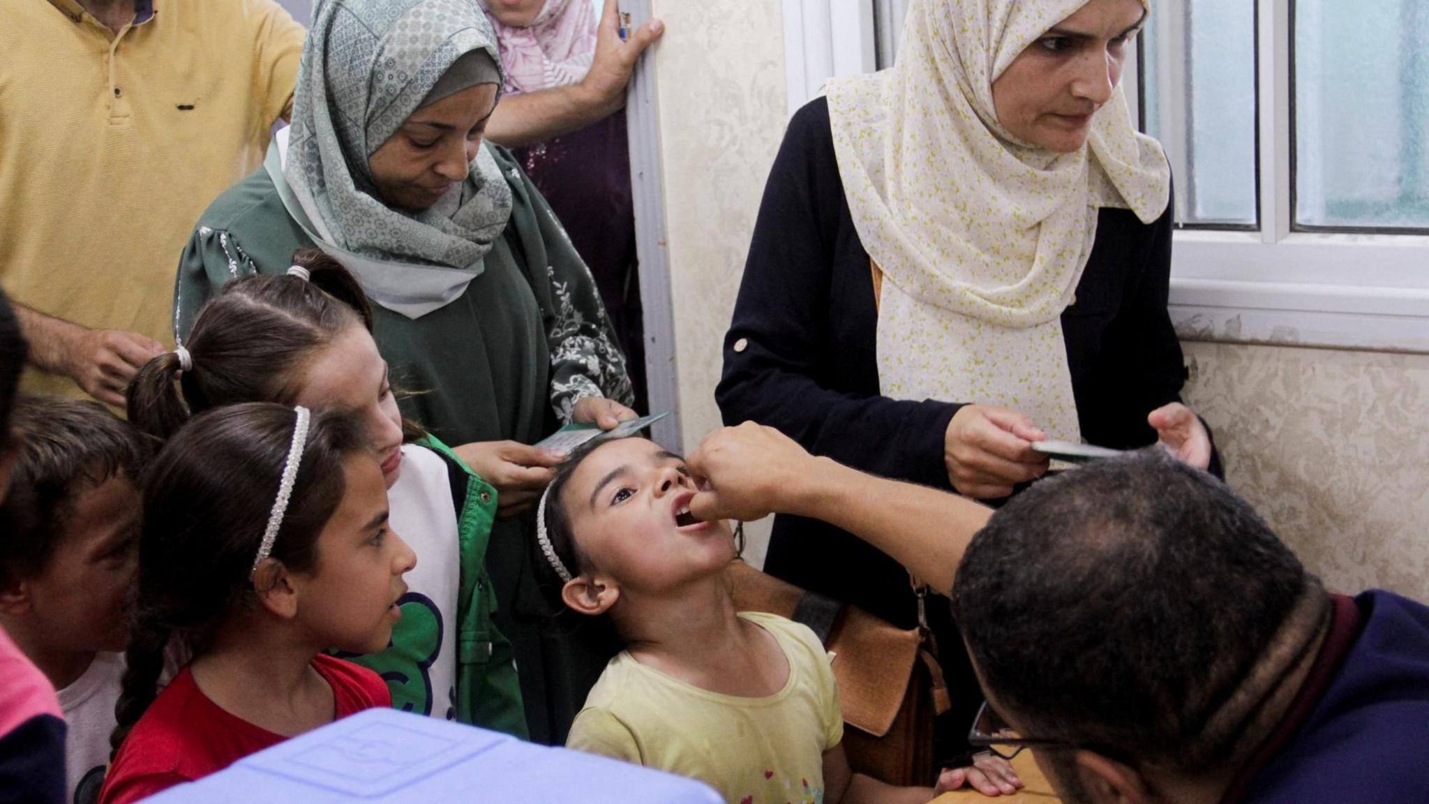 A girl is given an oral polio vaccine in Jabalia, in northern Gaza Strip (10 September 2024)