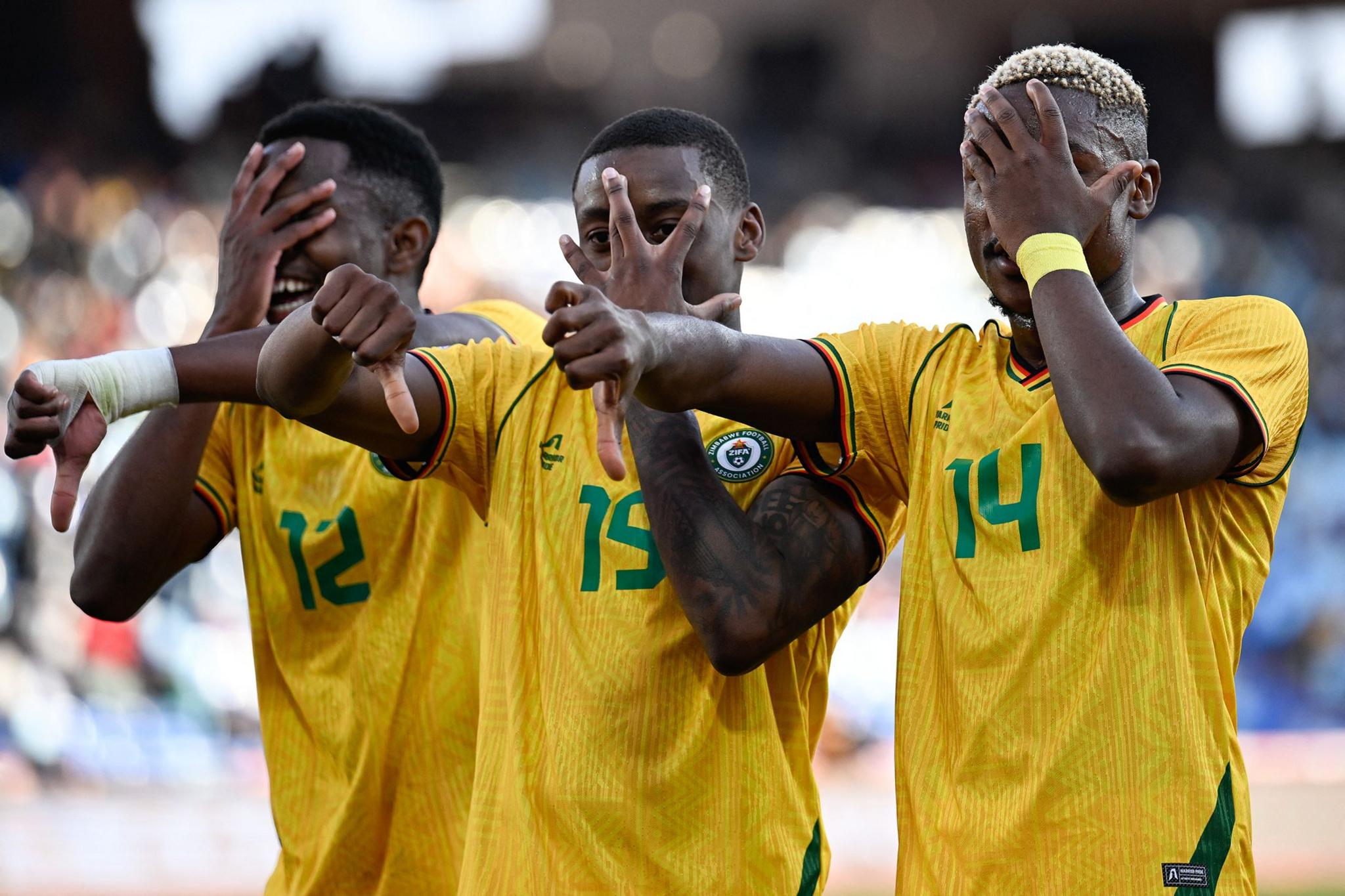Zimbabwe's Tawanda Maswanhise, centre, celebrates scoring the team's first goal with Bill Antonio and Daniel Msendami during their Africa Cup of Nations match against South Africa at Marrakesh Stadium. Photo by Khaled DeSouki