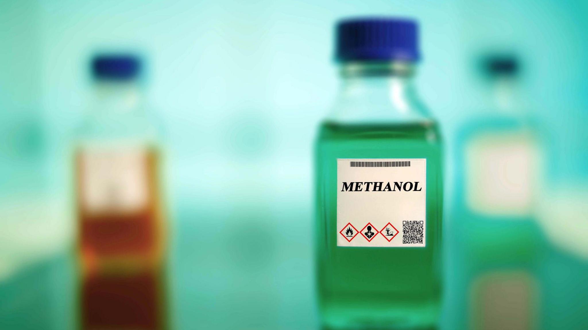 small bottle of methanol with a blurred background