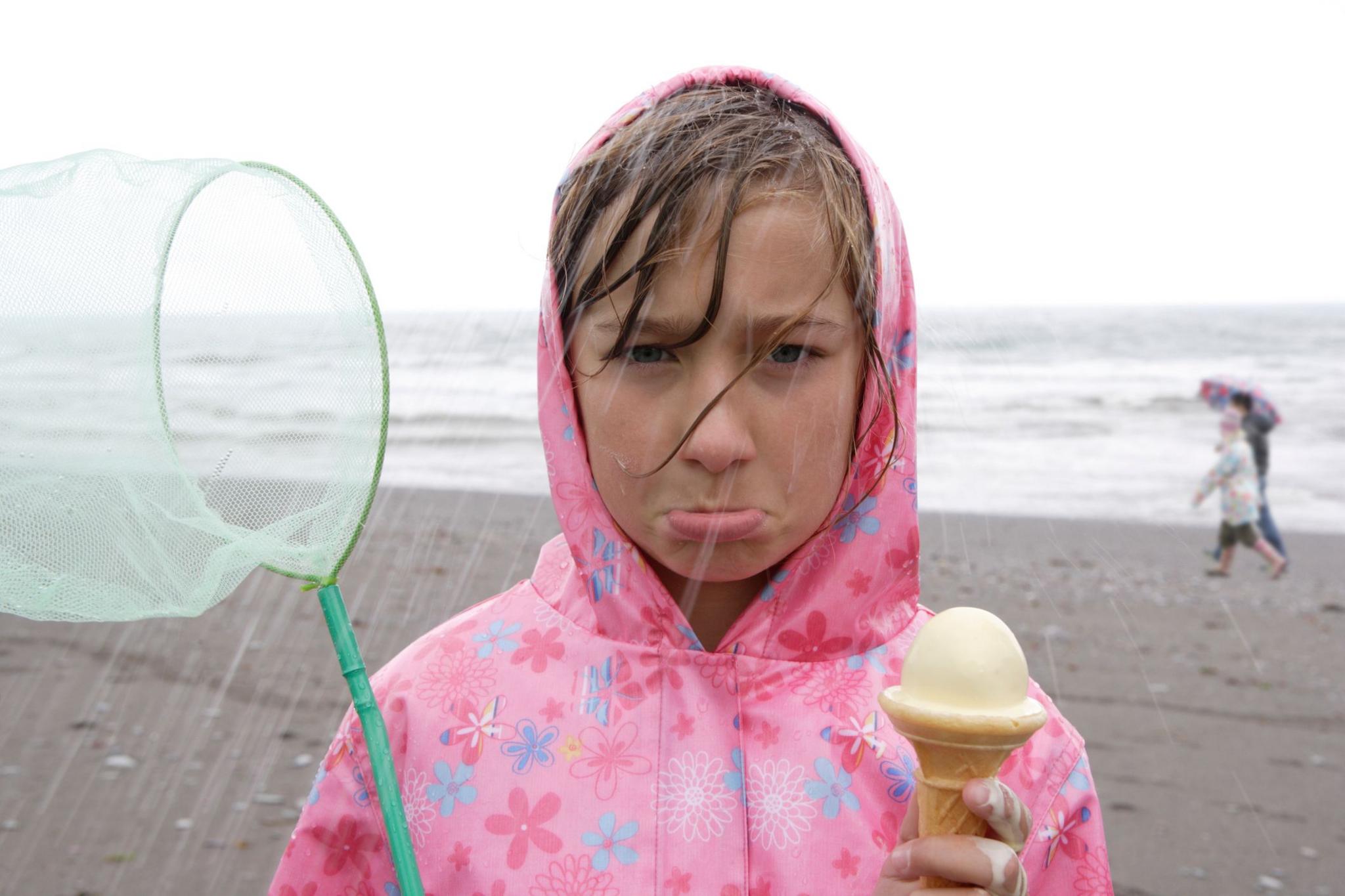 Girl wearing pink raincoat with flowers 