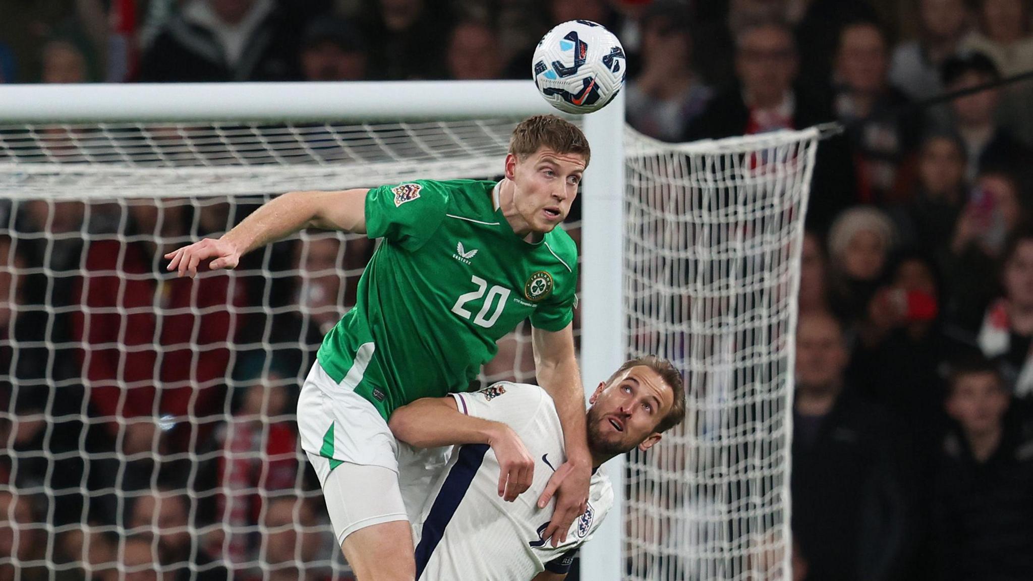 Mark McGuinness beats Harry Kane in the air