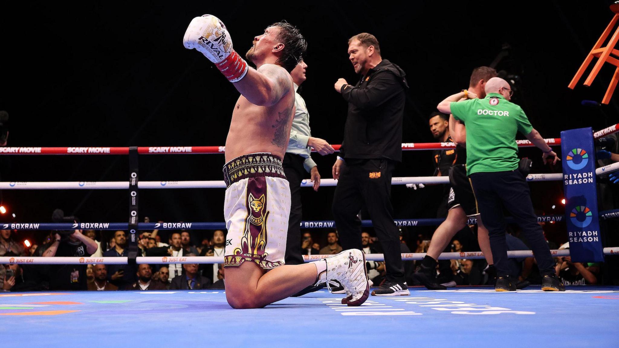 Oleksandr Usyk celebrates on his knees