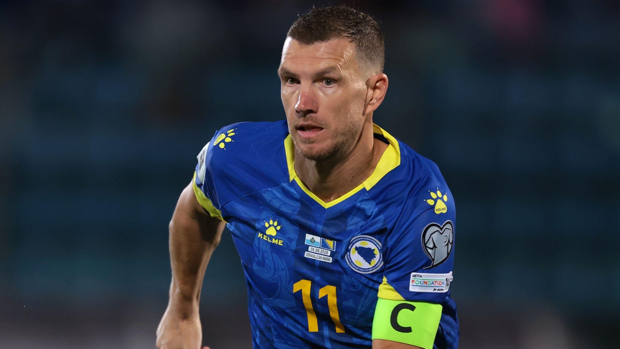Edin Dzeko wearing the captain's armband in the blue kit of Bosnia-Herzegovina