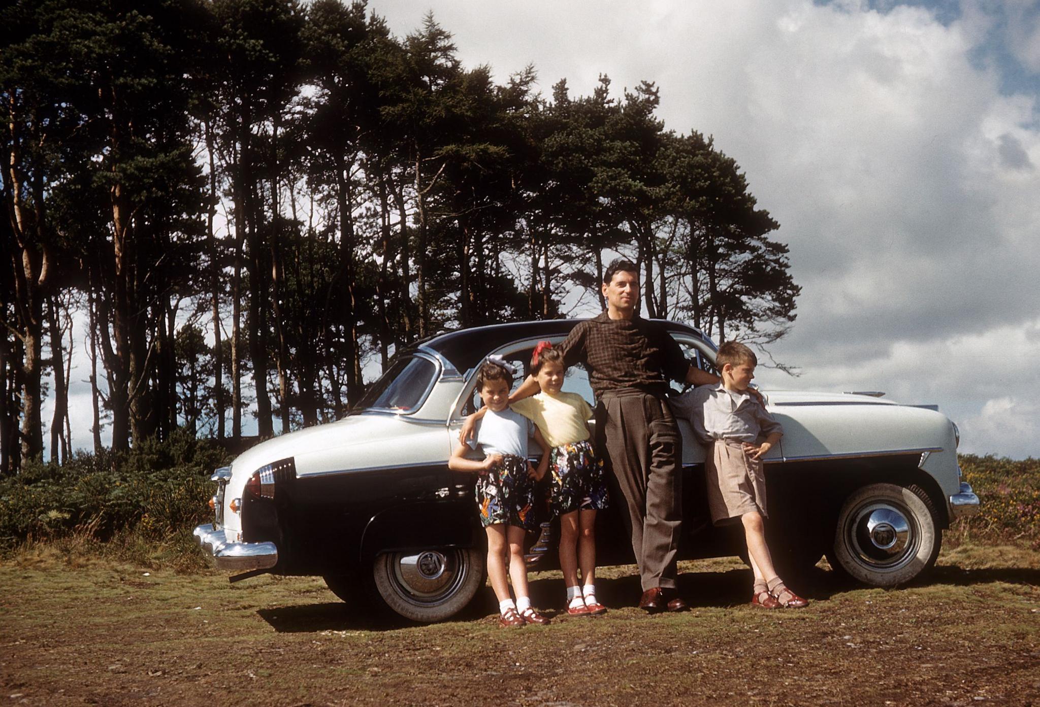 A father and his children beside a 1954 Vauxhall Cresta on Woodbury Common, Devon, in 1960
