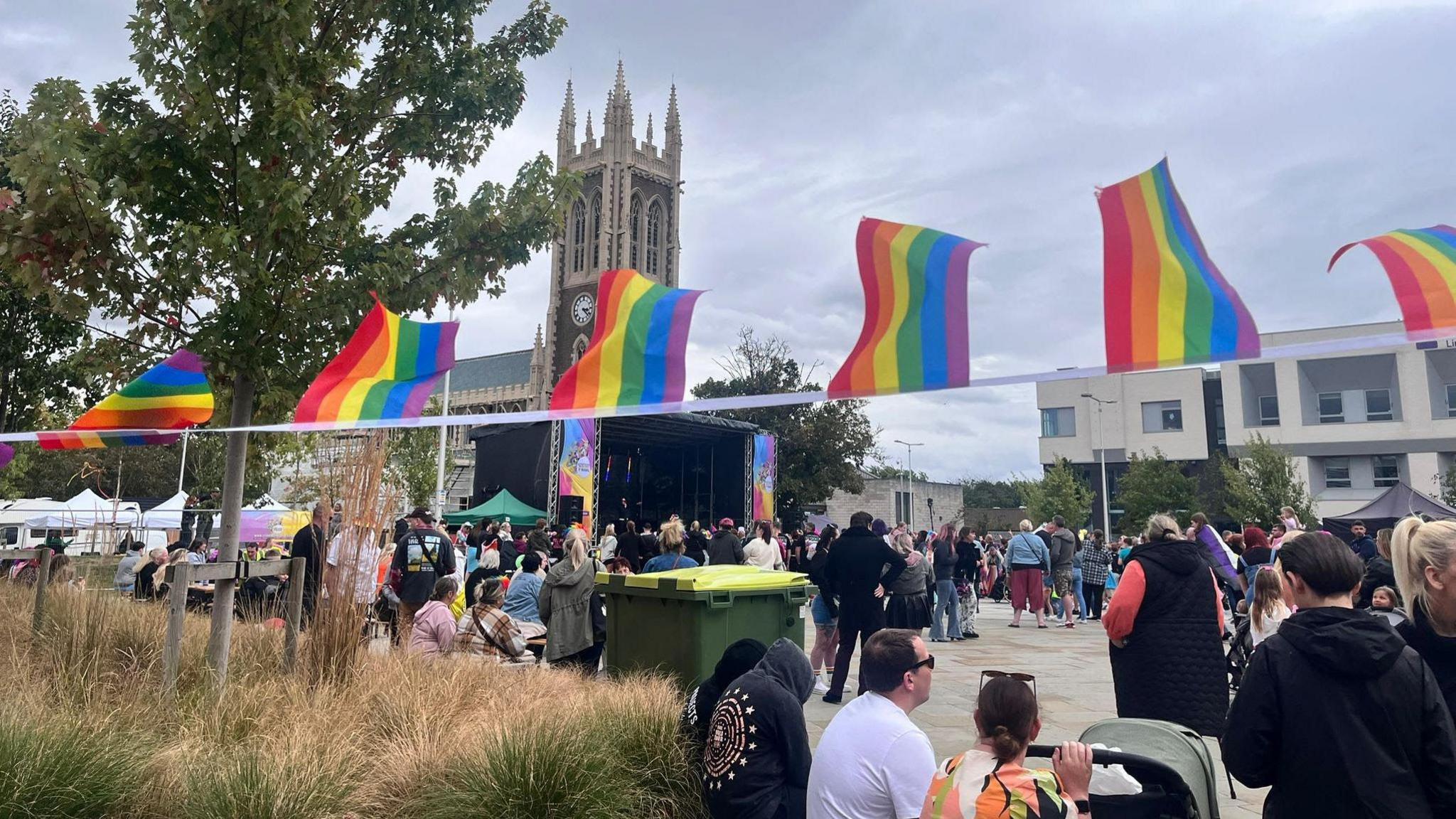 Families and attendees gather in Church Square, which was decorated in rainbow bunting.