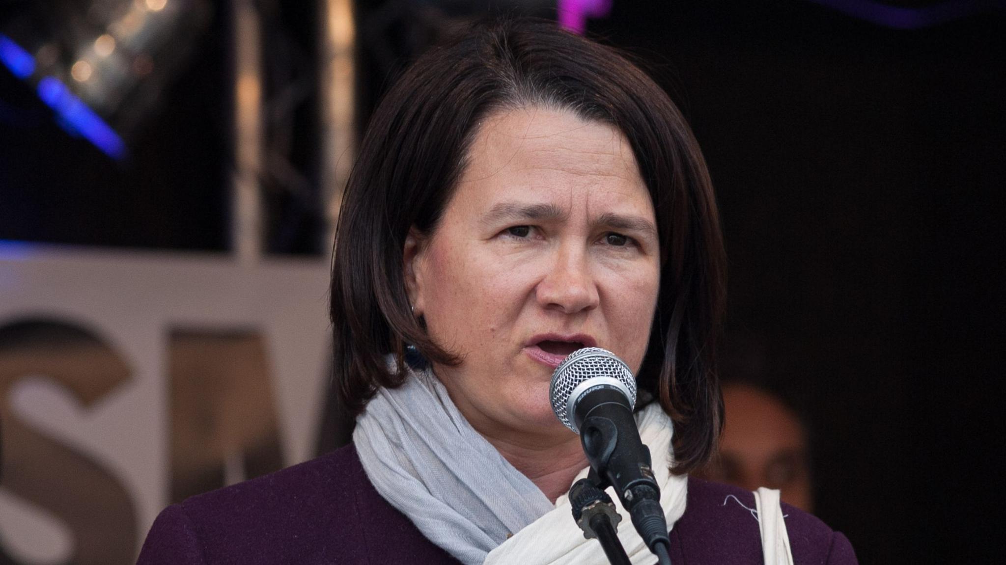 Catherine West speaks into a microphone in 2017.