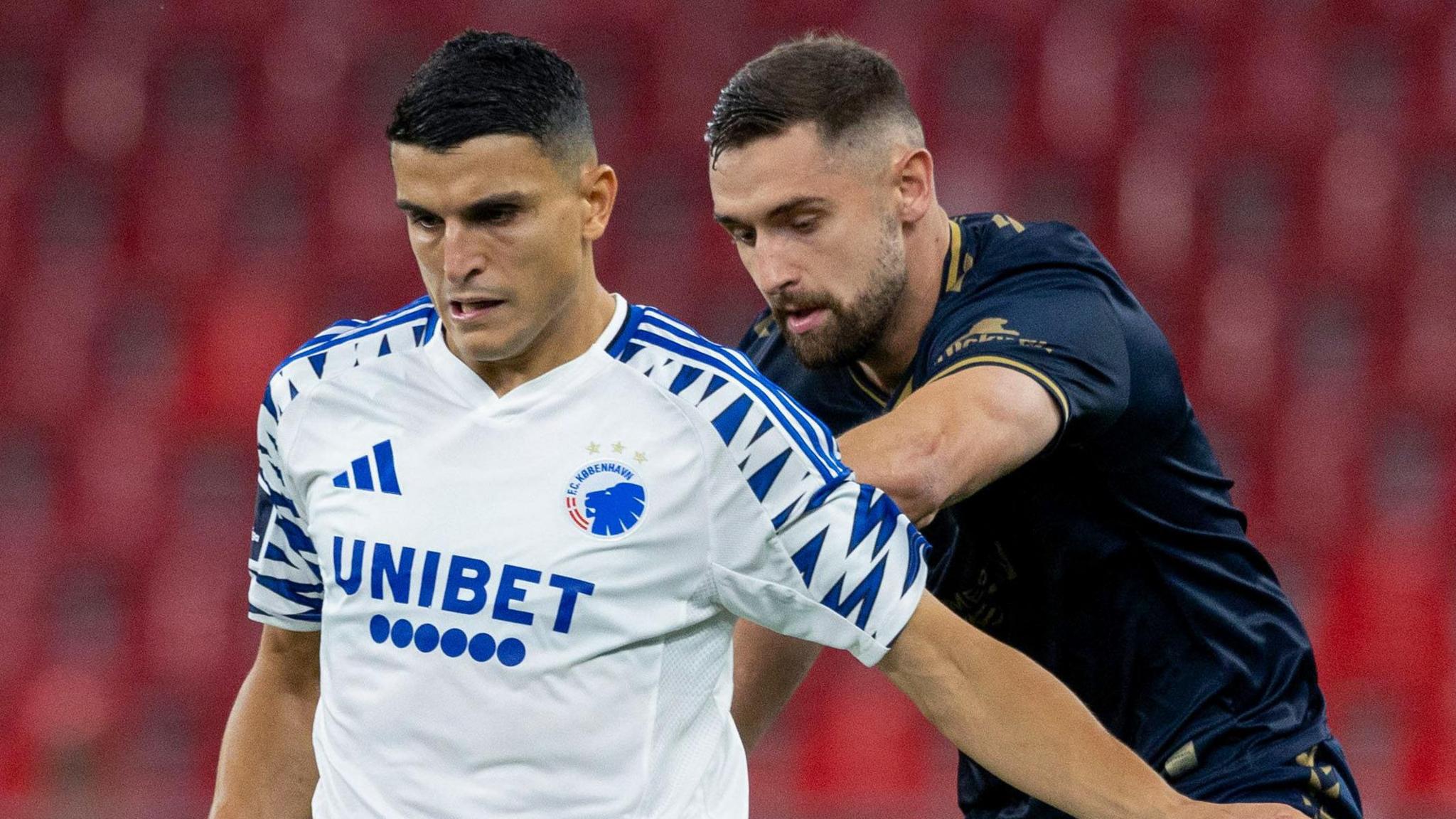 Copenhagen's Mohamed Elyounoussi (L) and Kilmarnock's Robbie Deas in action during a UEFA Conference League play-off match between FC Copenhagen and Kilmarnock at Parken Stadion