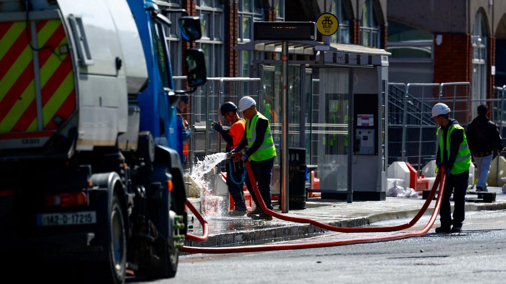 Cleaning crews washing down the streets near Mount Street