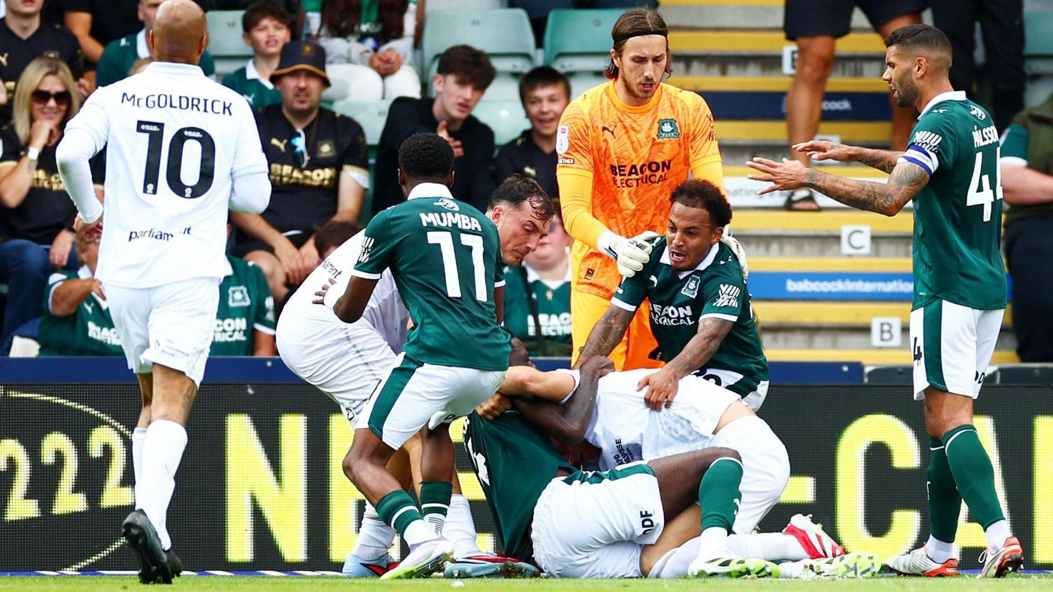 Plymouth Argyle and Barnsley players have a scuffle
