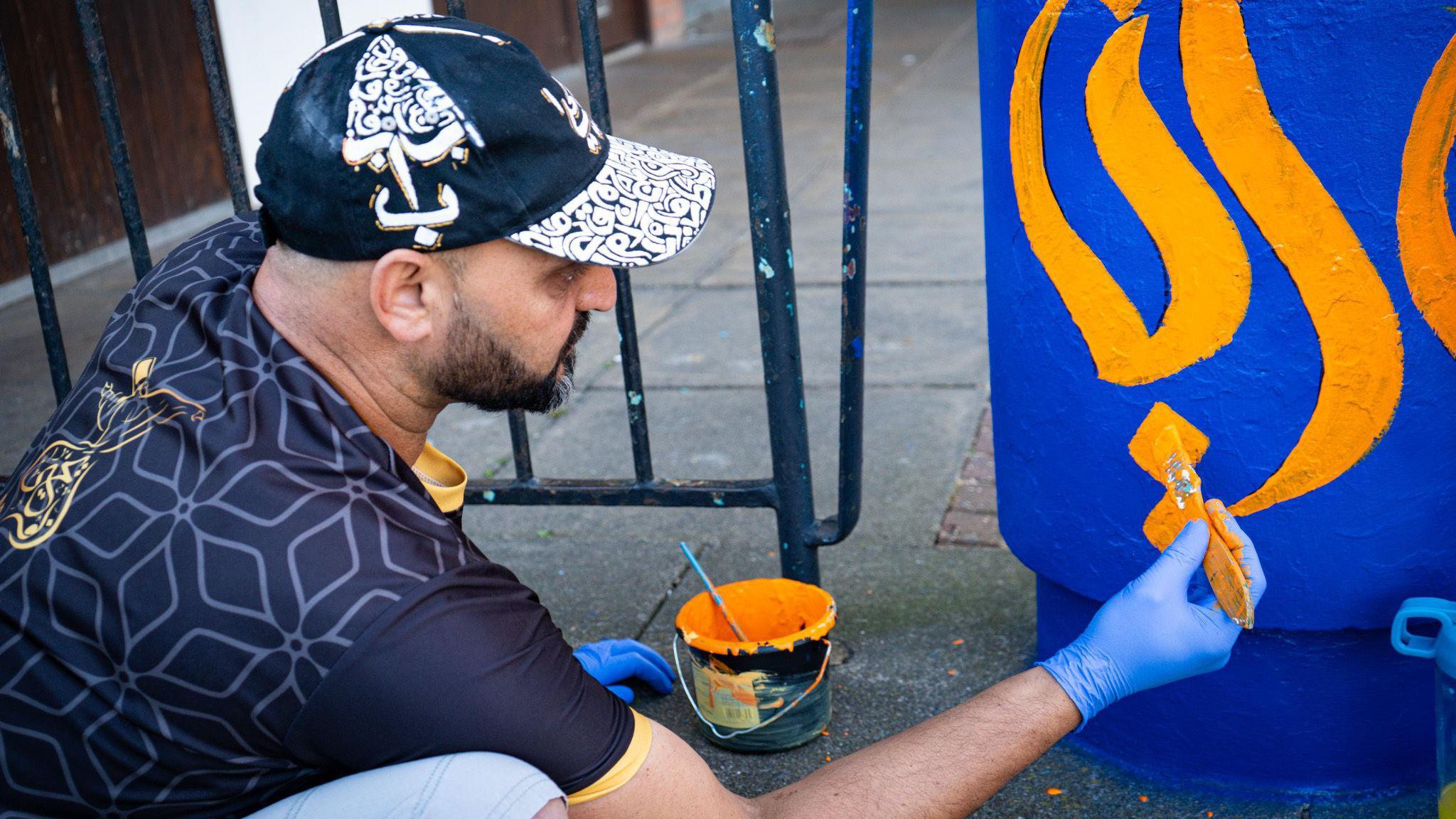 A community member from Farley Hill painting a pillar