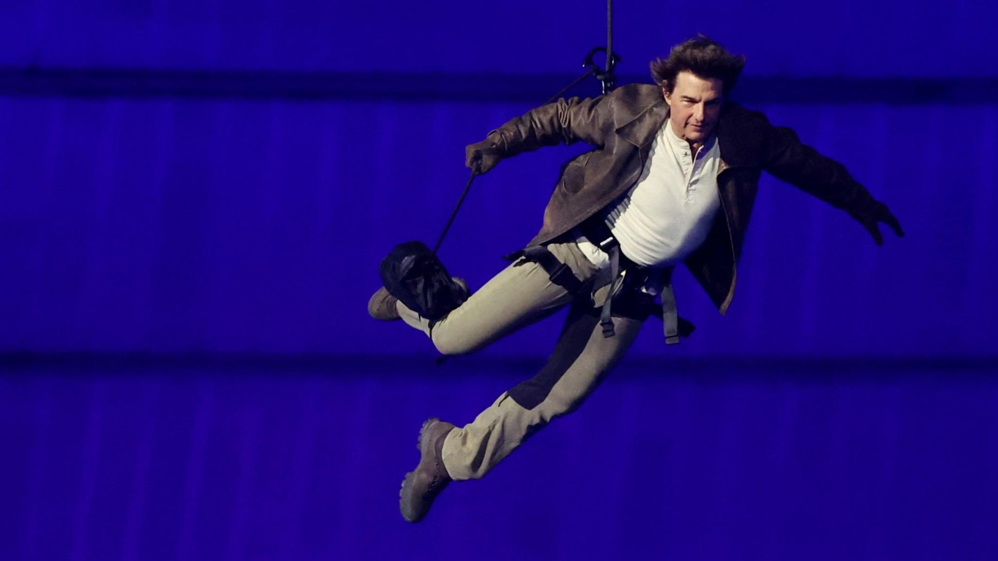 Tom Cruise descends into Stade de France